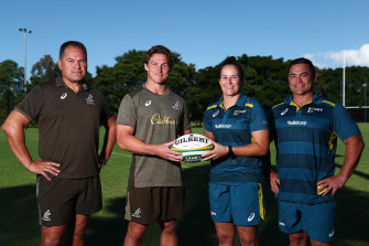 Wallabies coach Dave Rennie and captain Michael Hooper pose with Wallaroos assistant coach Sione Fukofuka and Shannon Parry.