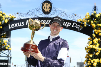 Jockey Jye McNeil with the Melbourne Cup. 