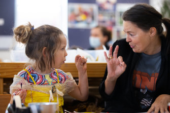 Freyja, a student from Coburg Children’s Centre, being taught Auslan by Julie Joyce.