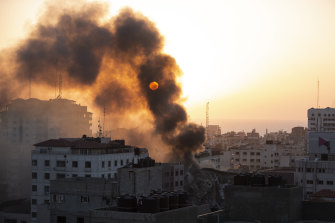 Smoke is seen from a collapsed building after it was hit by Israeli airstrikes on Gaza City.