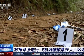 Video footage run by China’s CCTV showed debris marked by numbers at the site of the crash.