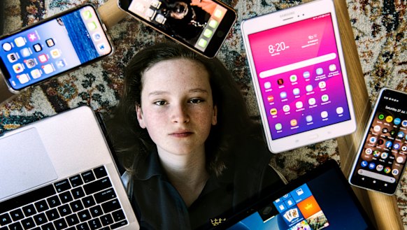 Grace Cox, 12, surrounded by devices in her Paddington home.