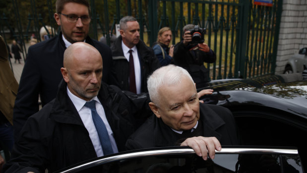 Poland’s conservative ruling Law and Justice party leader Jaroslaw Kaczynski gets in a car after casting his ballot in Warsaw.