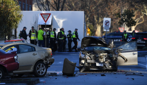 Police investigate a car accident at the scene of the brawl.