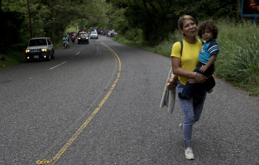 Honduran migrant Mary Dominguez carries her two-year-old son Dominic into Esquipulas in Guatemala on Tuesday.