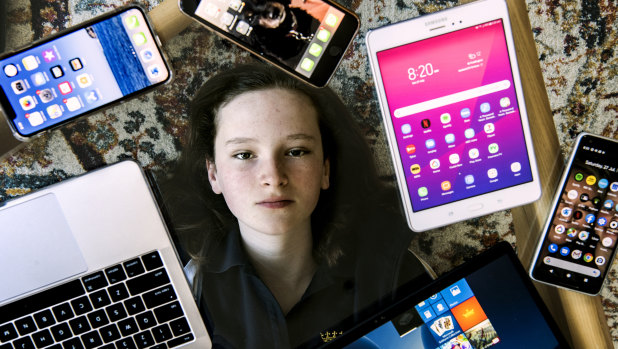 Grace Cox, 12, surrounded by devices in her Paddington home.