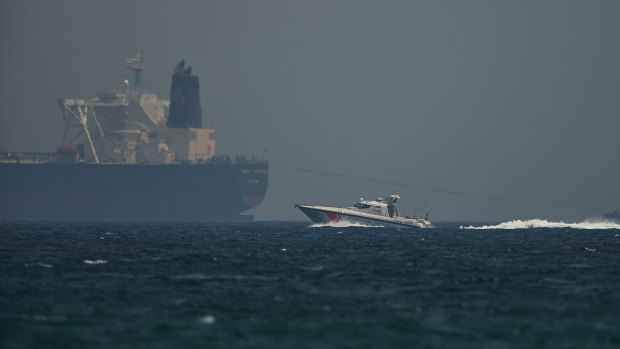 An Emirati coast guard vessel passes an oil tanker off the coast of Fujairah, United Arab Emirates.