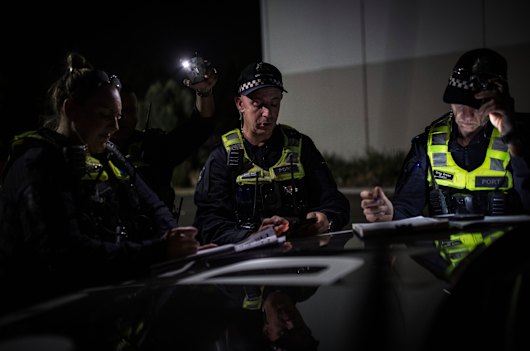 Senior Sergeant Nicole Beale, Acting Sergeant Paul Harris and Sergeant Greg Green work on plans for an operation.