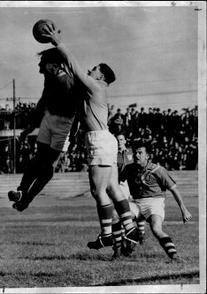 Ron Lord makes a timely intervention to deny Gordon Nunn in front of goal while playing for NSW in 1950.