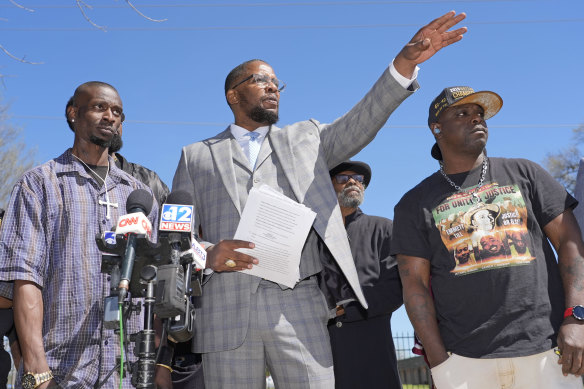 Michael Corey Jenkins (left) and Eddie Terrell Parker (right) with their lawyer Malik Shabazz outside court.