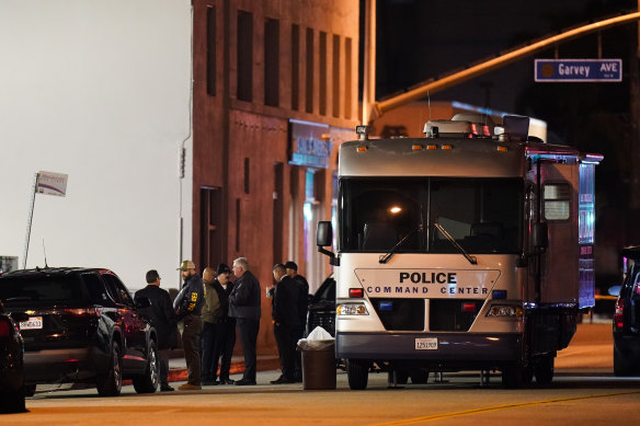 Investigators gather at a scene of the mass shooting.