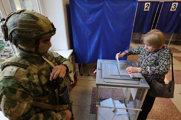 A voter casts a ballot during Russia’s parliamentary election, in the Russian-controlled part of the Donetsk region, Ukraine.