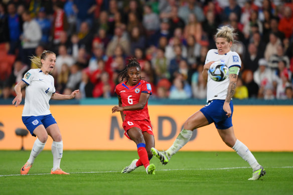 Melchie Dumornay takes a shot past England captain Millie Bright.