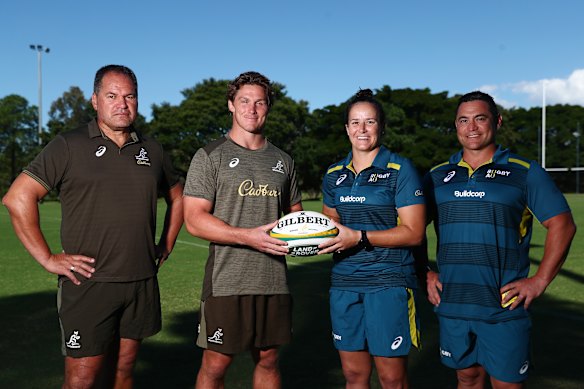 Wallabies coach Dave Rennie and captain Michael Hooper pose with Wallaroos assistant coach Sione Fukofuka and Shannon Parry.