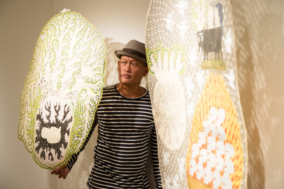 Artist Jumaadi with his work at Mosman Art Gallery.