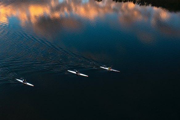Kayakers exercising at dawn on Narrabeen Lagoon during Covid lockdown