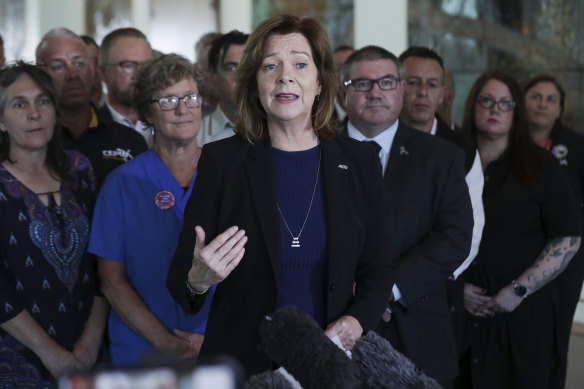 ACTU president Michele O’Neil with emergency services workers, one group the unions say will be hurt by new laws, at a press conference.