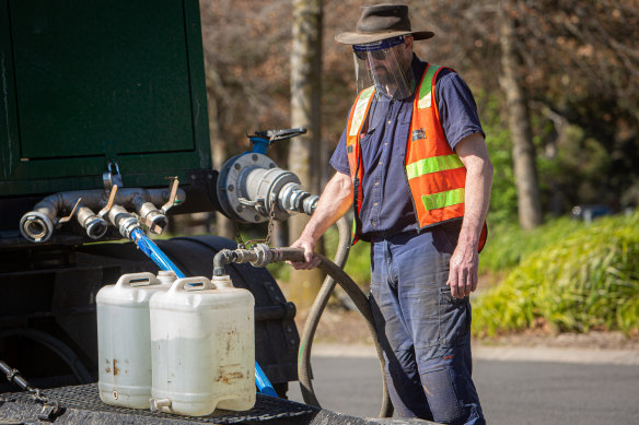 Residents collected clean drinking water from a tanker in the car park of the Ferntree Gully Arboretum on Saturday.