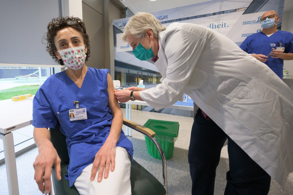 Zeynep Kallmayer, chief nurse of the Covid-19 intensive care unit at Johann Wolfgang Goethe University Hospital, receives a dose of the Pfizer vaccine from Professor Sabine Wicker in Frankfurt, on Sunday. 