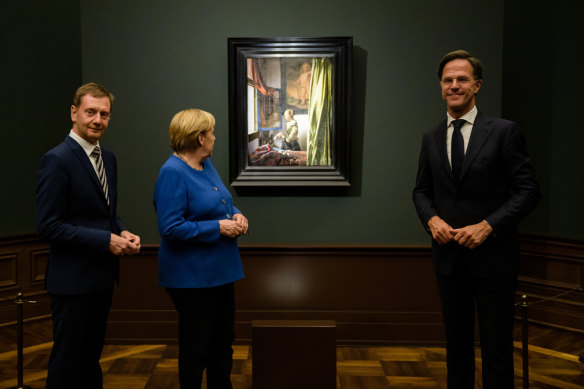 Stands out: Dutch Prime Minister Mark Rutte, 193cm, right, with Prime Minister of Saxony Michael Kretschmer, left, and German Chancellor Angela Merkel, in Dresden, Germany, earlier this month.