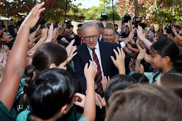 Primary school students mob the PM in Perth on Thursday.
