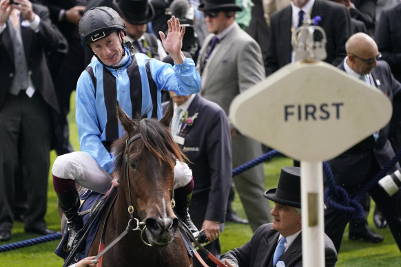 Jockey Oisin Murphy waves to the crowd from the winners enclosure on board Australian sprint Asfoora after winning the King Charles II Stakes race on the first day of the Royal Ascot. 
