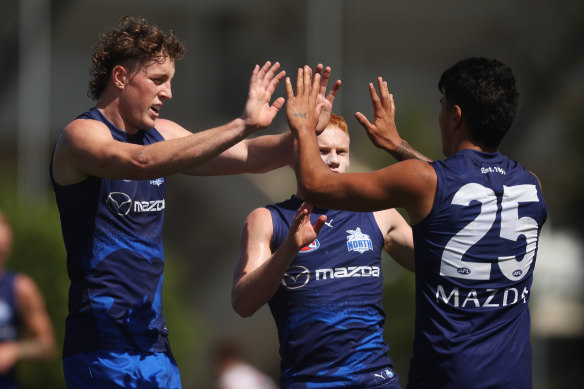 North Melbourne spearhead Nick Larkey acknowledges teammate Paul Curtis after slotting one of his five goals in the match simulation against Collingwood.