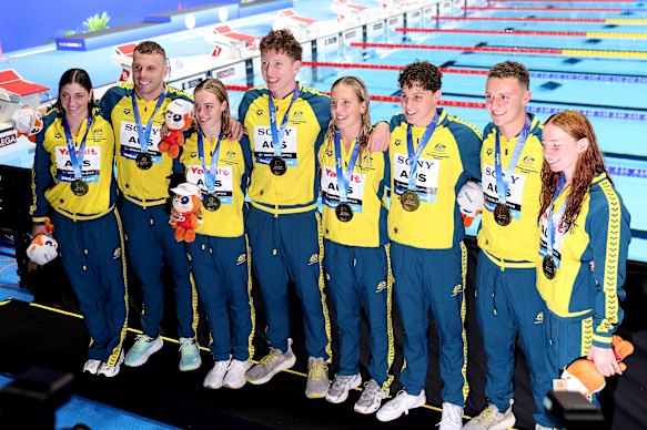 Australia’s men’s and women’s 4x100m freestyle relay teams celebrate gold medals at the world championships in Singapore. 