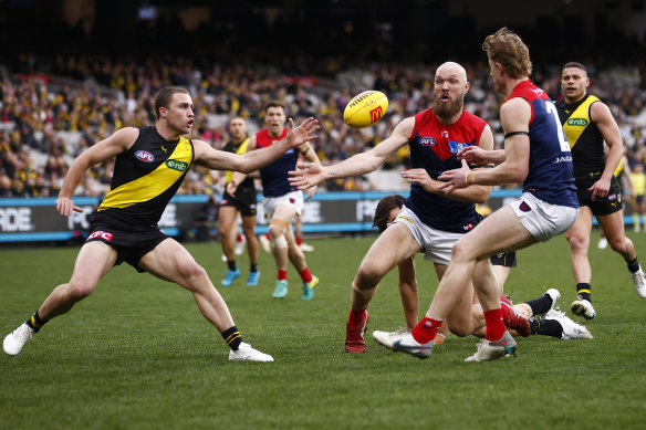 Max Gawn of the Demons slaps the ball forward.