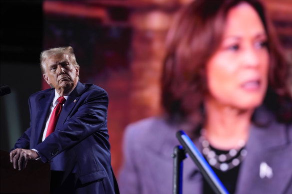 Donald Trump at a campaign event in Detroit on Friday, watching a video of opponent Kamala Harris.