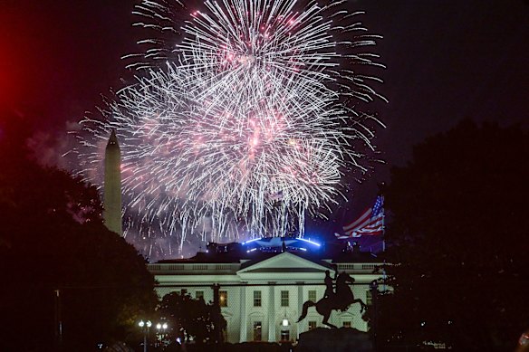 Fireworks explode above the White House.