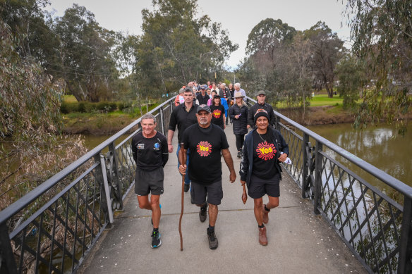 Michael Long (centre) re-enacts his long walk from Melbourne to Canberra in support of the Voice to parliament. Long was joined by former MPs and athletes Pat Farmer and Nova Peris.