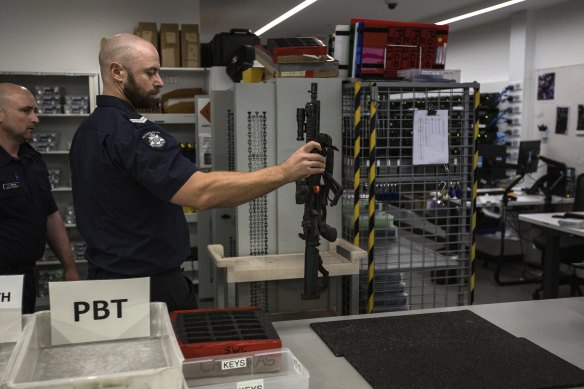 Members of Victoria Police Public Order Response Team check out weapons before their shift.