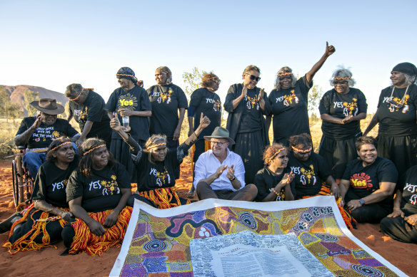 The prime minister receiving a copy of the Uluru statement. 