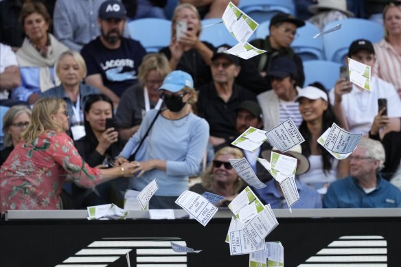 A woman throws “Free Palestine” leaflets onto Margaret Court Arena.