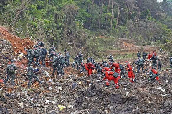 Search crews examine the wreckage of China Eastern flight MU5735.