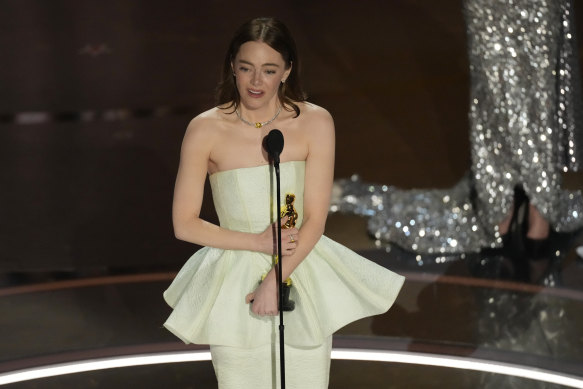 Emma Stone accepts the best actress award.