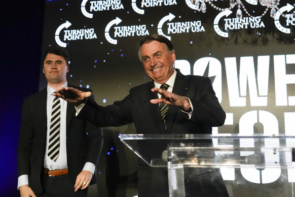 Brazil’s right wing former President Jair Bolsonaro, right, speaks alongside Turning Point USA founder Charlie Kirk, at a TPUSA event at Trump National Doral, Miami.