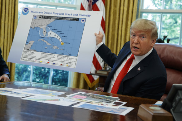 President Donald Trump shows a map forecasting the path of Hurricane Dorian.