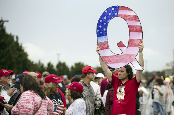 A protester holds a Q sign while waiting to enter a campaign rally with President Donald Trump in Wilkes-Barre, Pennsylvania, in 2018.