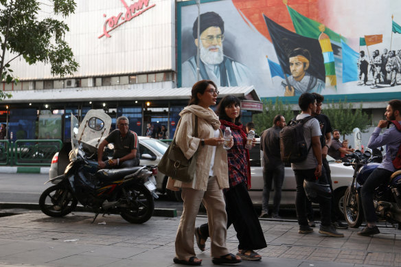 Iranian women walk on a street during the revival of morality police in Tehran on July 16.