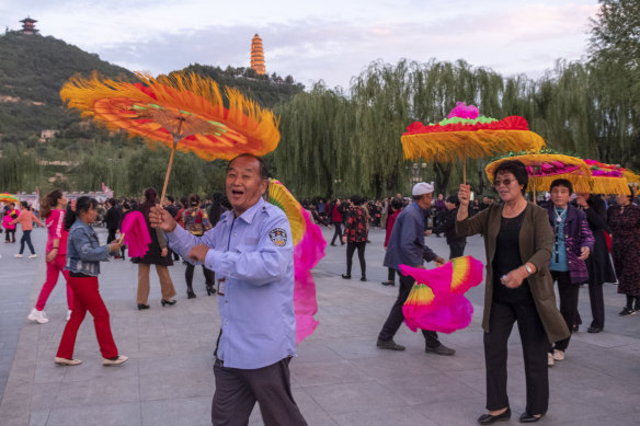 Yan’an locals enjoy square dancing, or plaza dancing, in the shadow of the town's Pagoda Hill.