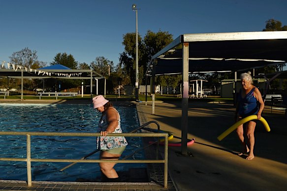 Joyce Newton enters the pool with friend Kay O’Dell for their daily early morning swim. 