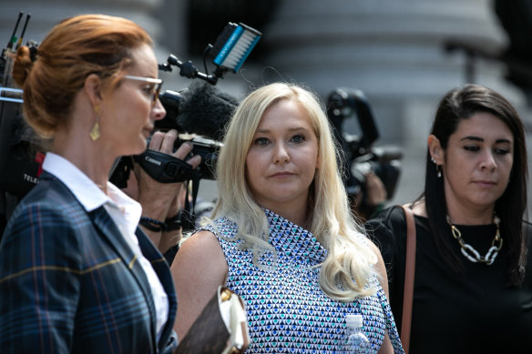 Virginia Giuffre (center) leaves New York federal court in 2019.