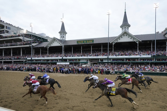 Rich Strike (21), with Sonny Leon aboard, heads down the straightaway on the way to winning the 148th running of the Kentucky Derby.