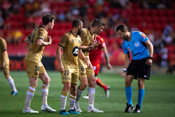 Referee Chris Beath explains to Western Sydney players why he gave Adelaide's first penalty.