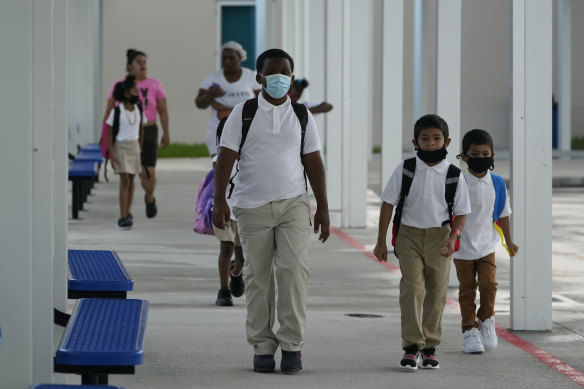 Children arrive for the first day of school on August 10 at Washington Elementary School in Florida, where schools have defied the Governor to mandate masks.
