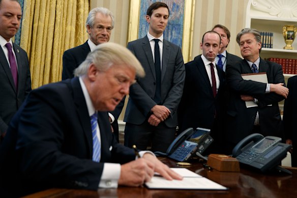 Navarro (second from left) pictured in 2017, is one of the few people who have been by Donald Trump’s side during three campaigns and two administrations.