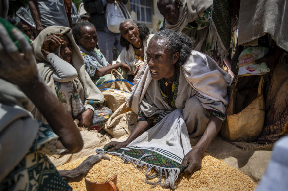 An Ethiopian woman argues with others over the allocation of yellow split peas after it was distributed by the Relief Society of Tigray in the town of Agula. 