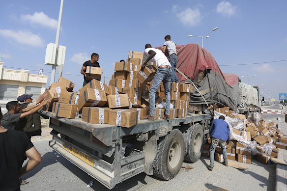 Palestinians loot a truck with humanitarian aid near the Rafah border crossing in the Gaza Strip  in 2023. 